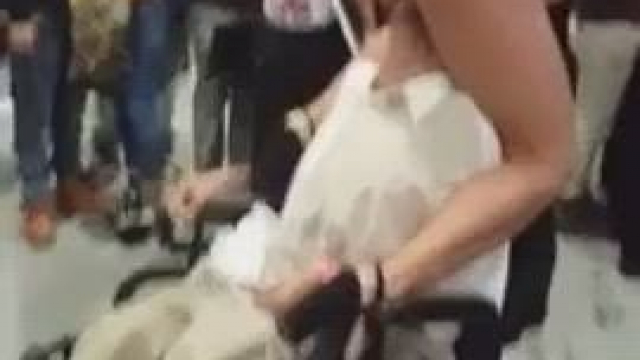 Adriana Chechik giving a disabled fan a taste