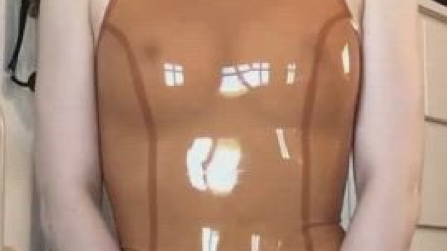Unzipping her latex one piece to flash her vagina