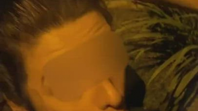 There are cars passing by but she just keeps sucking it