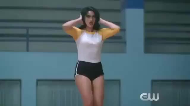 Camila Mendes strutting her stuff in a cheerleader outfit in 