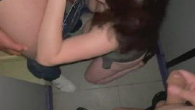 Sucking a stranger's penis at the glory hole sex arcade