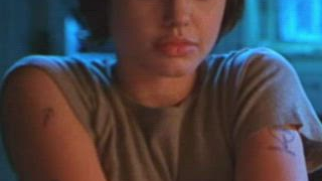 Angelina Jolie taking her shirt off in Foxfire