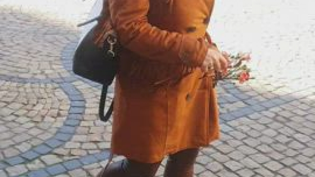 And such an ordinary walk of a modest girl with flowers in the old town square. 