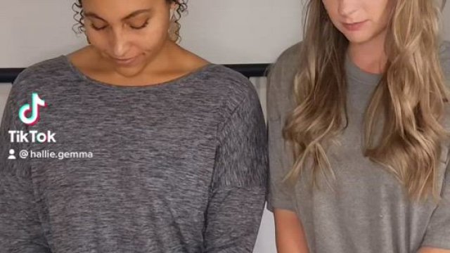 Two beautiful women kiss