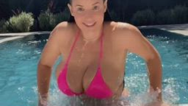 Propping herself up and jiggling her boobs before going back into the water