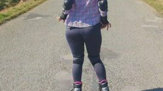 I wonder what the driver thought when he saw a girl on roller skates with a bare